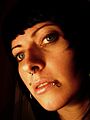 Portrait of dark haired girl with beautiful eyes and several piercings
