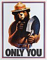 Drawing of a grizzly bear with human features. He is wearing blue jeans with a belt and a brimmed hat with the name "Smokey" on the cap and has a shovel in his left hand. He is pointing to the viewer while the text "Only You" is seen below him.