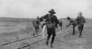 Soldiers laying demolition charges on railway tracks near Asluj May 1917