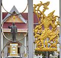 View of Kaysone Phomvihane Museum showing Sinxay figure in front gate with statue of Kaysone in the background