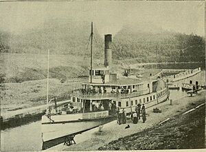 With fly-rod and camera (1890) (14759833816)