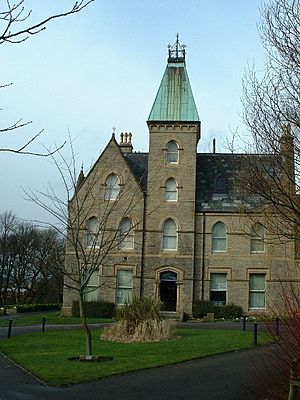 Photo of the exterior of Bagshaw Museum, a Gothic revival building situated in a landscaped park