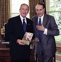 Bob Dole presenting President George W. Bush with signed book, 2005 (cropped)