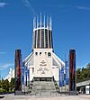 The front elevation of Liverpool Metropolitan Cathedral showing the steps rising from Hope Street and the bell tower in front of the church's spire.
