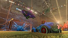 A car sits idly on a football pitch as another flies above him, following an explosion at the goal posts