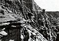 Photograph in black and white of rugged, fissured cliff face