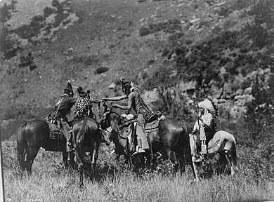 Crow men trading on horseback- Edward S. Curtis