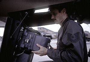 TSGT Glenn Farquhar loads film into camera equipment installed on an F-4 Phantom II aircraft prior to a mission during Exercise PHOTO Finish '81 - DPLA - 486aa8d404f489fd8b024d48388fb04f