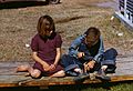 Arthur Rothstein, Boy building a model airplane as girl watches, FSA camp, Robstown, Texas, 1942