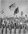 Gaunt allied prisoners of war at Aomori camp near Yokohama cheer rescuers from U.S. Navy. Waving flags of the United... - NARA - 520992