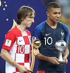 Kylian Mbappé and Luka Modrić receive the award for the best young player and best player in the 2018 World Cup respectively (cropped)