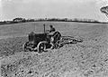 Man harrowing with tractor and disk harrow (1295027)