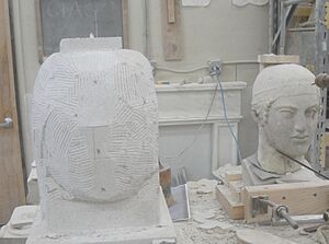 Pointing a copy of the Charioteer of Delphi in limestone