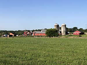 2023-08-02 08 27 02 View southwest from Mercer County Route 579 (Bear Tavern Road) across a field towards the main buildings at the Jones Farm Dairy Minimum Security Unit in Ewing Township, Mercer County, New Jersey