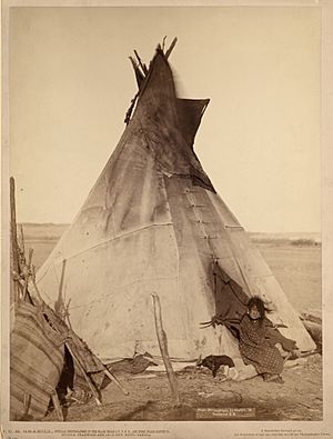 Oglala girl in front of a tipi