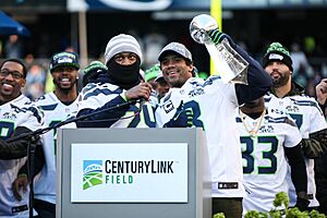 Russell Wilson, Marshawn Lynch with Lombardi Trophy