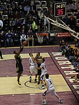 A teammate catches the ball near the hoop.