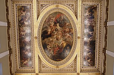 On a painted ceiling, angels surround a king dressed in red.
