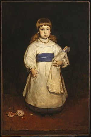 young girl standing with blue sash.