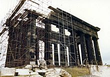 Penshaw Monument covered in scaffolding, with parts of its entablature missing