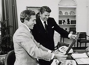Robert DeProsepero and Ronald Reagan look at a print of Rancho Del Cielo 1982