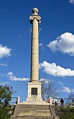 A tall fluted granite Ionic column topped with a stone globe.