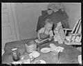 Son of Charles B. Lewis, miner, playing around kitchen table in home in company housing project. Union Pacific Coal... - NARA - 540564