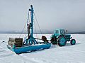 Tractor and rig for drilling holes for ice fishing