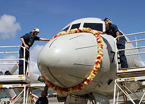 US Navy 040603-N-6501W-055 Sailors assigned to the Golden Swordsmen of Patrol Squadron Four Seven (VP-47), carefully places a flower lei on the nose of a P-3C Orion