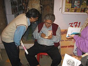 Sunil Gangopadhyay giving autographs to his fans in Kolkata Book Fair 2010 by Piyal Kundu