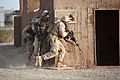U.S. Marines with the 3rd Battalion, 6th Marine Regiment, 2nd Marine Division prepare to clear and breach a building during a mock helicopter raid at Yuma Proving Ground, Ariz., April 9, 2014, as part of Weapons 140409-M-HR724-049