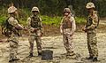 Bermudan soldiers with Guns and Assault Platoon, and a U.S. Marine with 2nd Combat Engineering Battalion, discuss training after they complete a wired connection on Marine Corps Base Camp Lejeune, N.C., May 2 130502-M-BW898-002