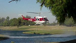 Fire helicopter extracting water from Carbon Canyon Park lake