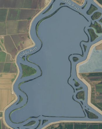Aerial photo of a tiny ring of grass around an enormously flooded island.