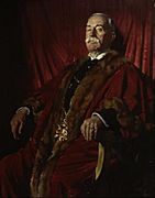 Man seated and wearing red fur trimmed robes and chain of office