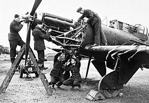 Fitters working on the Rolls-Royce Merlin engine of a Boulton Paul Defiant of No. 125 Squadron RAF at Fairwood Common, Wales, January 1942. CH4607