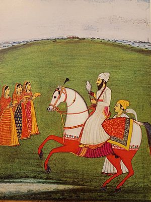 Guru Arjan hunting while mounted on horseback with a hawk