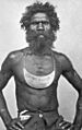 Man wearing breastplate inscribed King Sandy Brisbane 