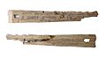 Two small pieces of wood, slightly triangular in shape; these are two halves of the same piece of wood. The top piece shows writing in old English; the lower is rougher.