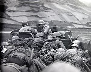 Men of the 89th Division, U.S. Third Army, cross the Rhine River at Oberwesel, Germany, 28 March 1945