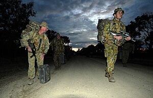 Soldiers from 2-14th Queensland Mounted Infantry scout a road prior to troop and vehicle movements during exercise Talisman Sabre 2007 at Shoalwater Bay Training Area