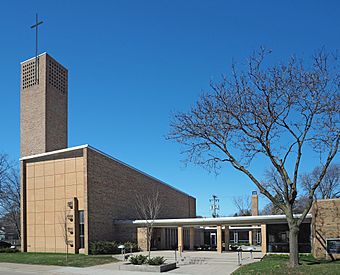 Minimalist church with a rectilinear sanctuary and steeple tower flanked by an arcaded plaza