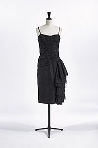 A black cocktail dress with spaghetti straps on a mannequin.
