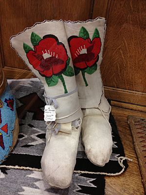 Crow moccasins white with beadwork of red flowers