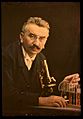 Louis Lumiere with microscope and test tubes