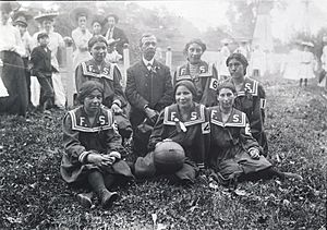 Members of Fort Shaw Indian girls' basketball team (Front- G. Butch, B. Johnson, E. Sansaver; Back- N. Wirth, Mr. McCutcheon, K. Snell, M. Burton)