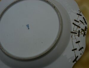 Underside of a Meissen plate, with c.C19th staples