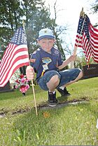 A Cub Scout, with Troop 319, places an American flag on the gravesite of a U.S. Soldier who served in the Spanish-American War at Calvary Cemetery in Grand Forks, N.D., May 24, 2013 130524-F-JB669-040.jpg