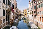 A channel in Venice with boats parked