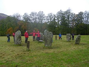 Drizzly image of stone circle with wet people